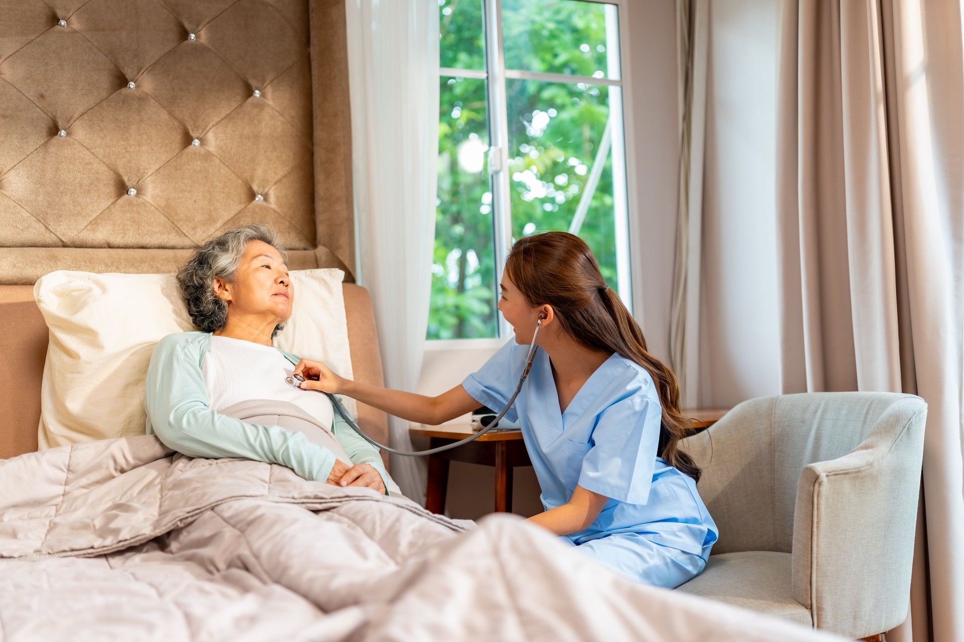 Female doctor examine senior patient at home.